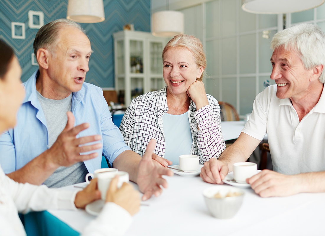 Medicare - Group of Elderly People Sitting Together Having Coffee and a Chat