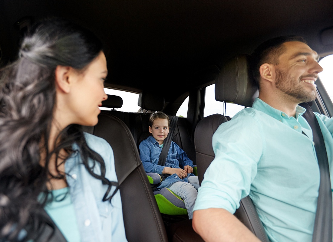 Personal Insurance - Happy Family and Young Son Sit Inside Their Car